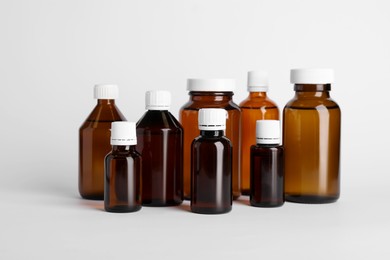 Photo of Medical bottles with medicine on white background