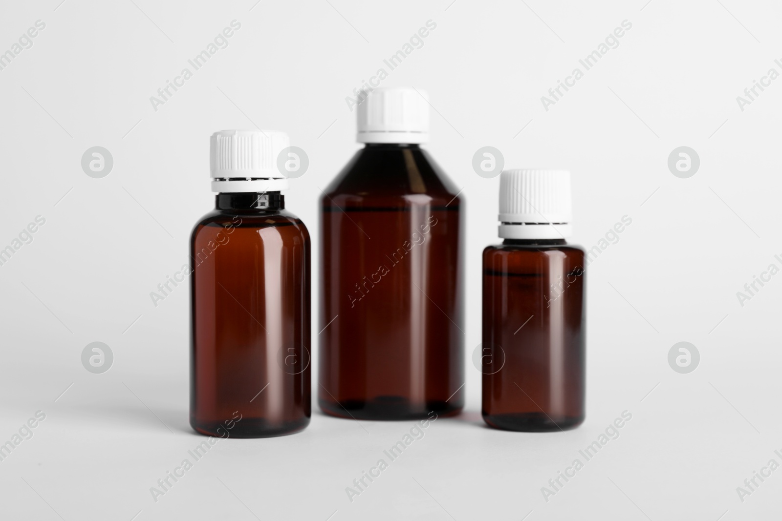 Photo of Medical bottles with medicine on white background