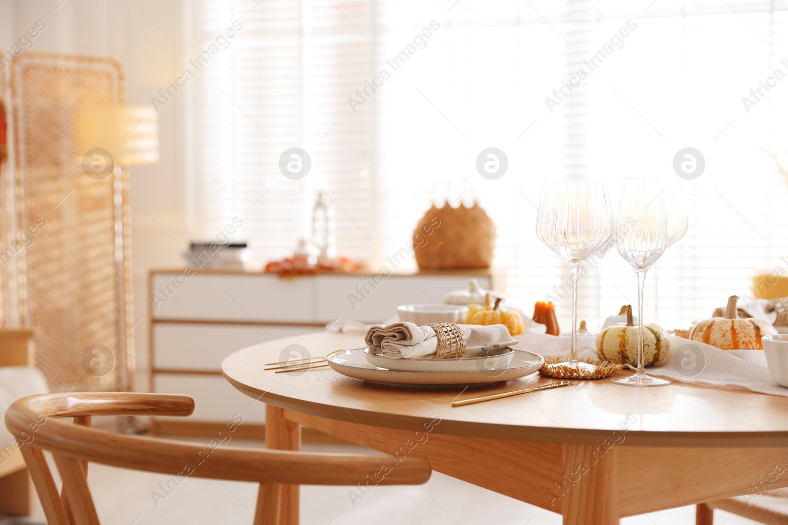 Photo of Stylish table setting with beautiful dishware and autumn decor in dining room