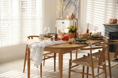 Stylish dining room with beautiful table setting and autumn decor