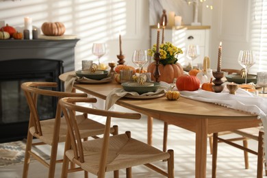 Photo of Stylish dining room with beautiful table setting and autumn decor