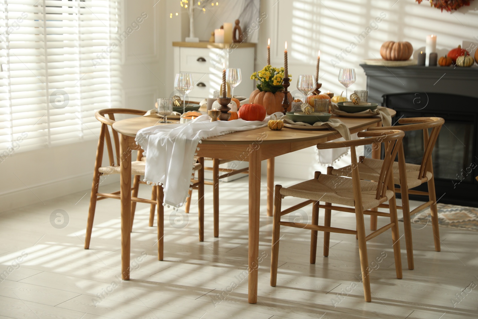 Photo of Stylish dining room with beautiful table setting and autumn decor