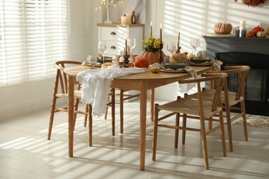 Stylish dining room with beautiful table setting and autumn decor