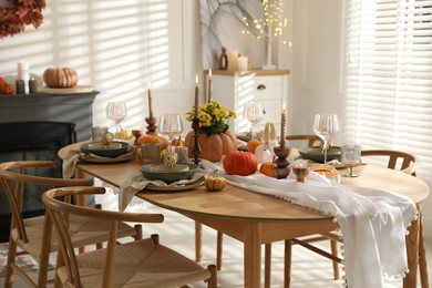 Photo of Stylish dining room with beautiful table setting and autumn decor