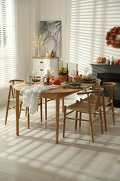 Stylish dining room with beautiful table setting and autumn decor