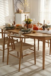 Stylish dining room with beautiful table setting and autumn decor