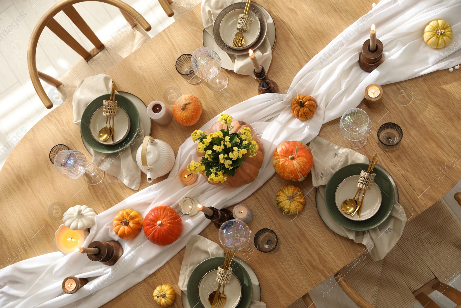 Photo of Stylish table setting with beautiful dishware, glasses and autumn decor in dining room, top view