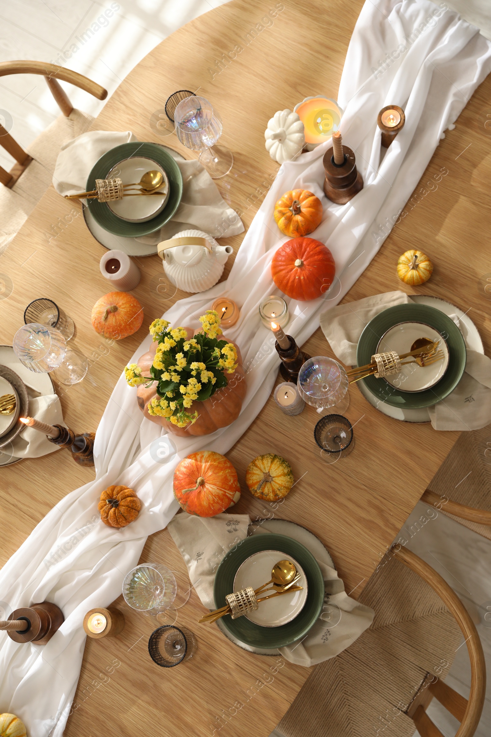 Photo of Stylish table setting with beautiful dishware, glasses and autumn decor in dining room, top view