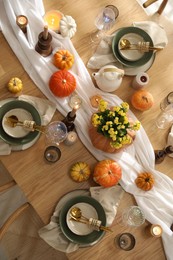 Stylish table setting with beautiful dishware, glasses and autumn decor in dining room, top view