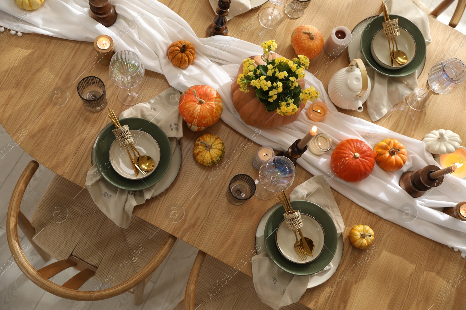 Photo of Stylish table setting with beautiful dishware, glasses and autumn decor in dining room, top view