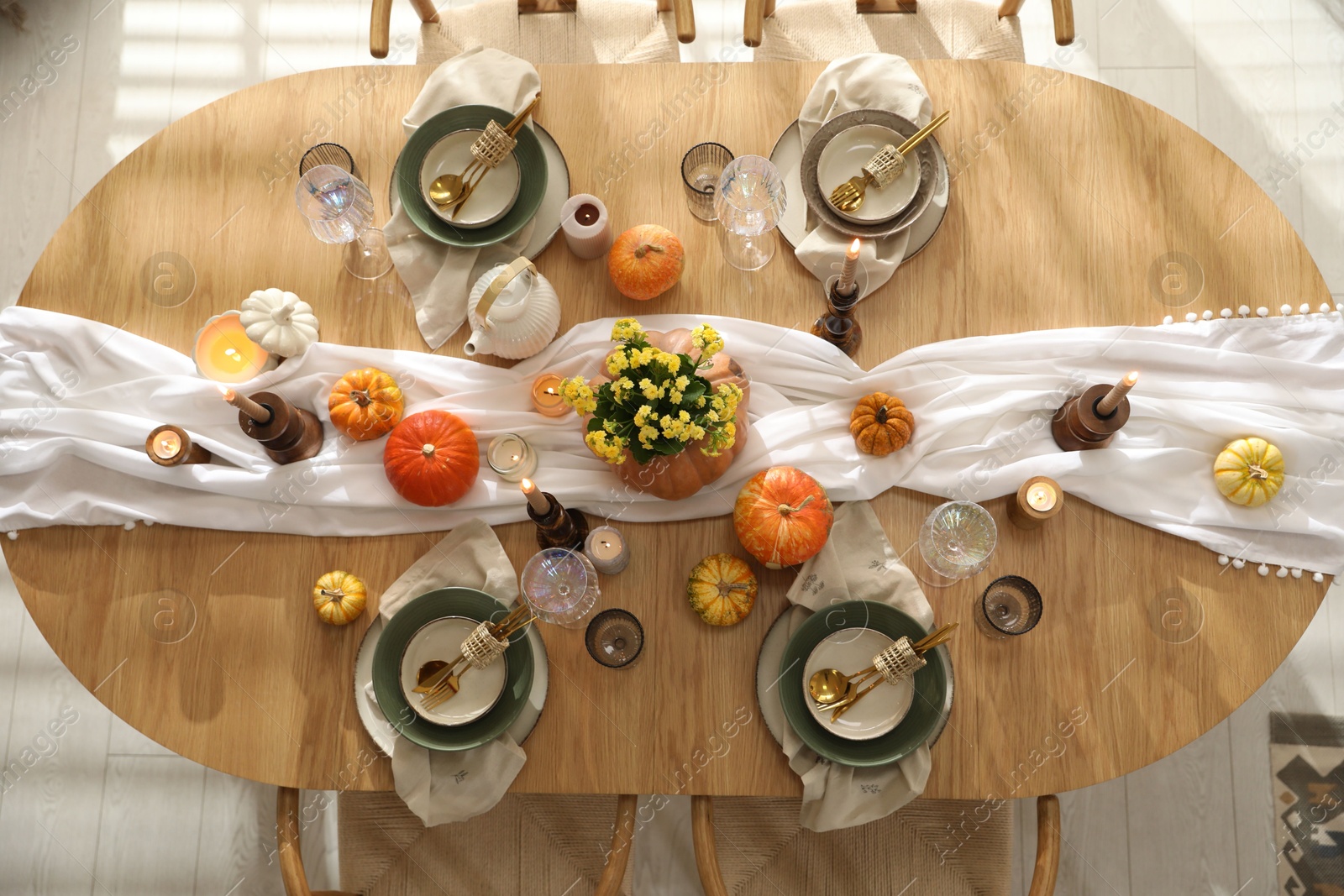 Photo of Stylish table setting with beautiful dishware, glasses and autumn decor in dining room, top view