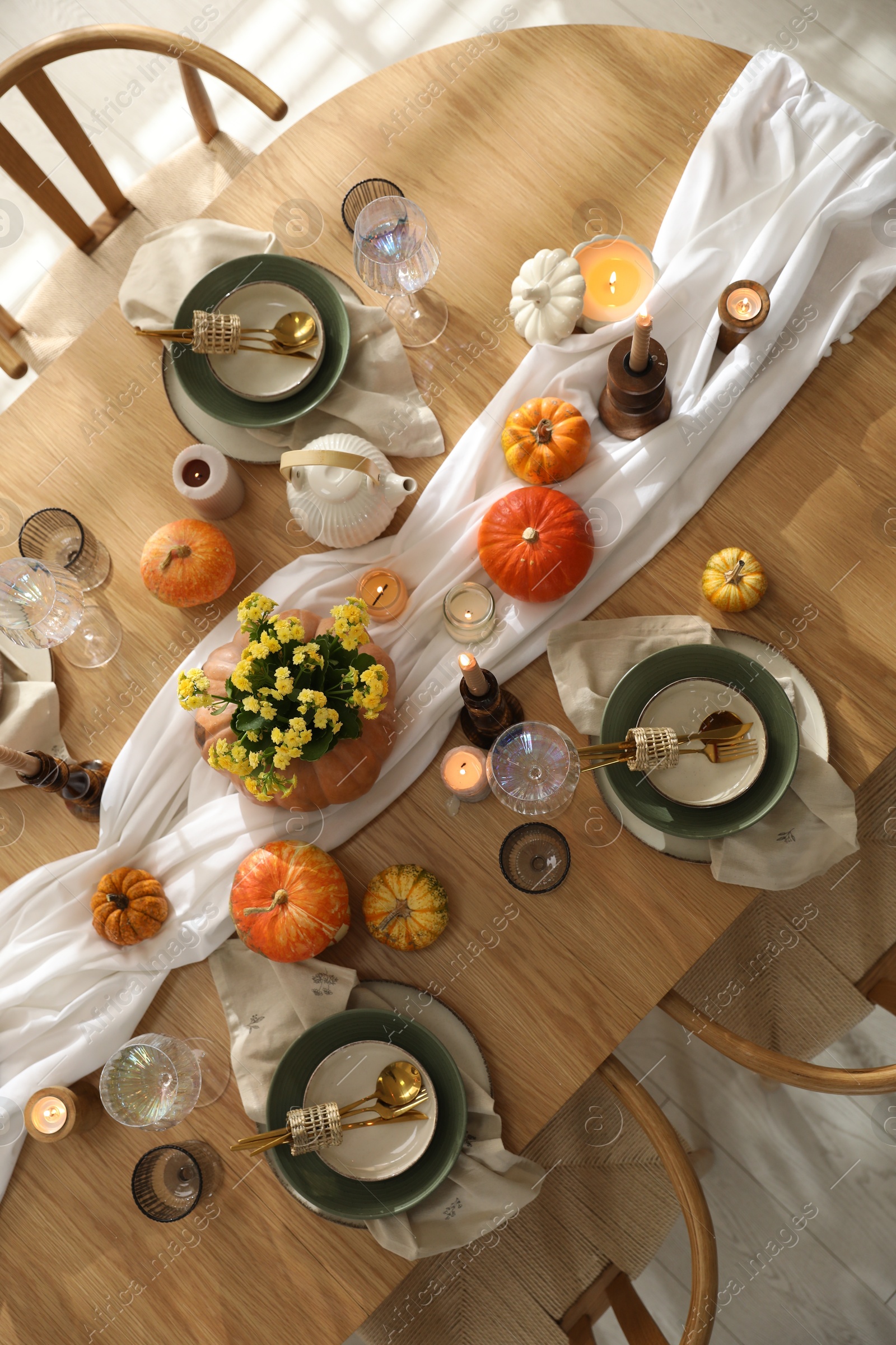 Photo of Stylish table setting with beautiful dishware, glasses and autumn decor in dining room, top view