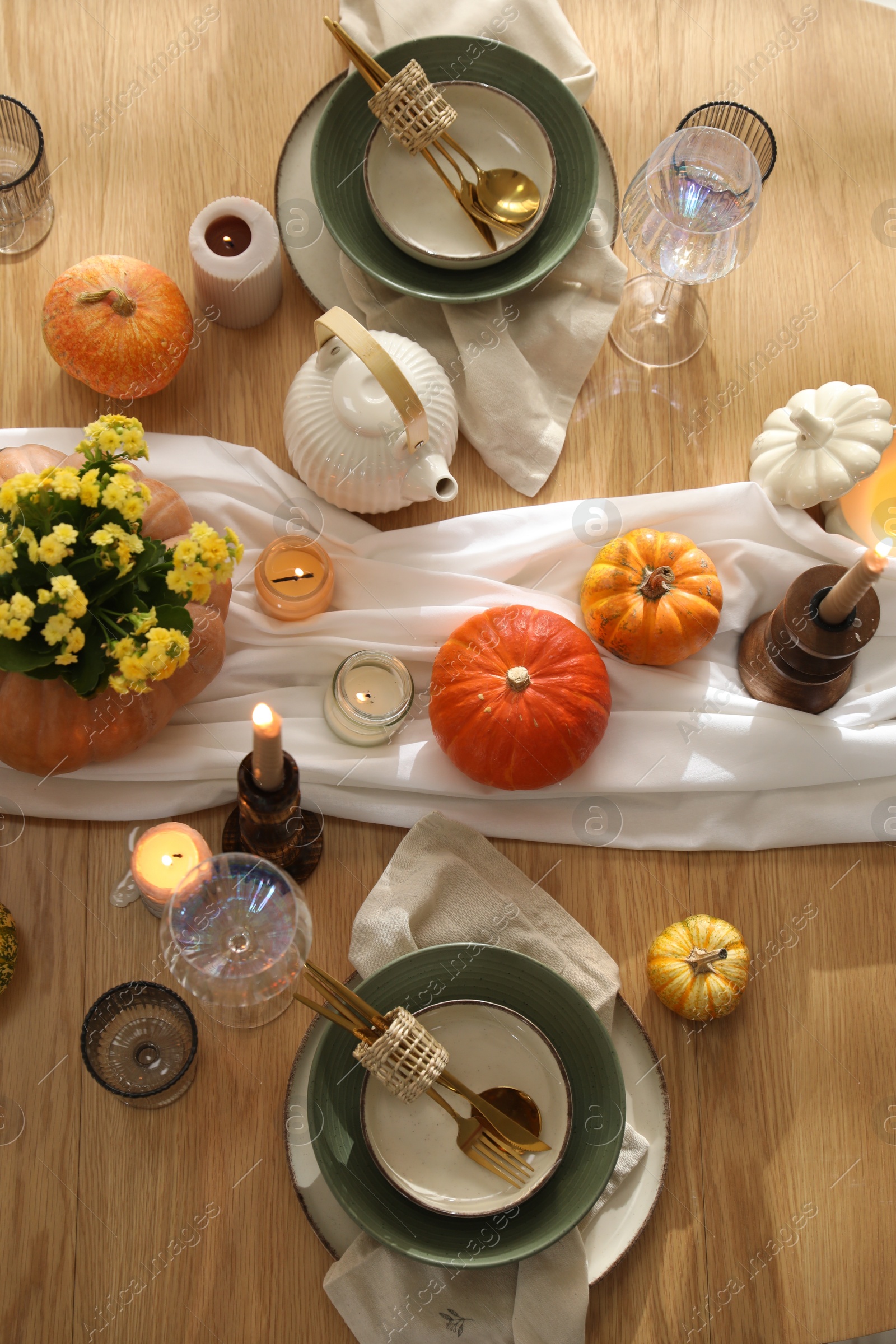 Photo of Stylish table setting with beautiful dishware, glasses and autumn decor in dining room, top view