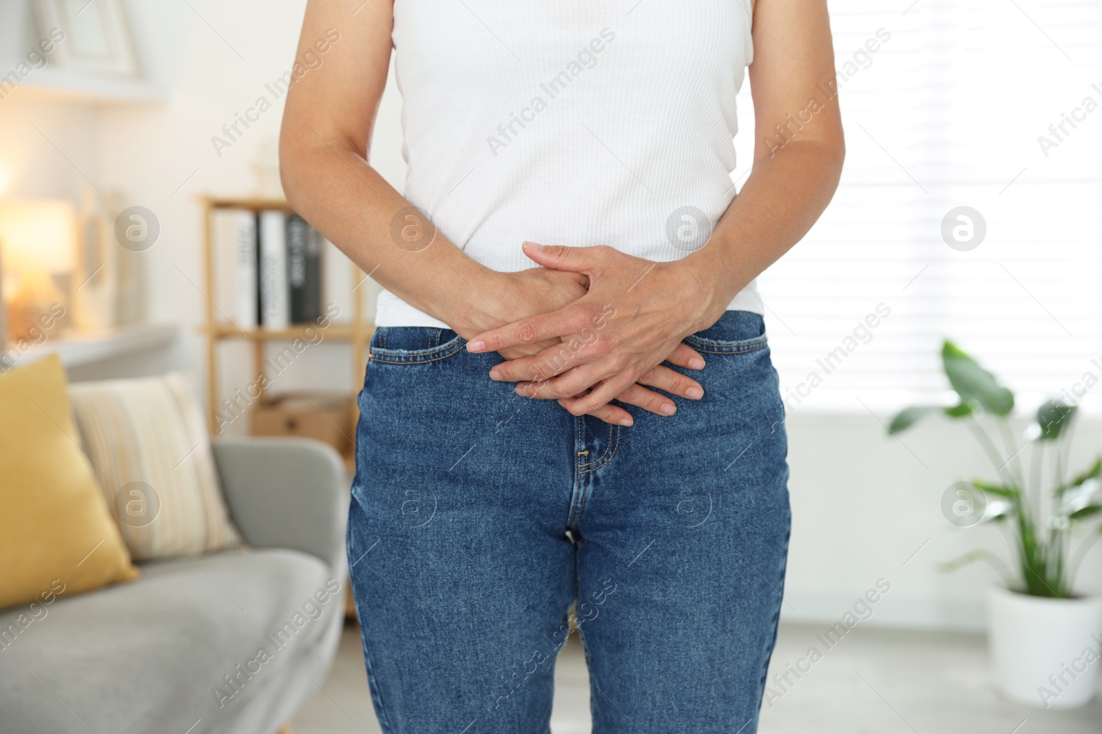 Photo of Menopause. Woman suffering from abdominal pain at home, closeup