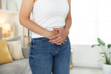 Photo of Menopause. Woman suffering from abdominal pain at home, closeup