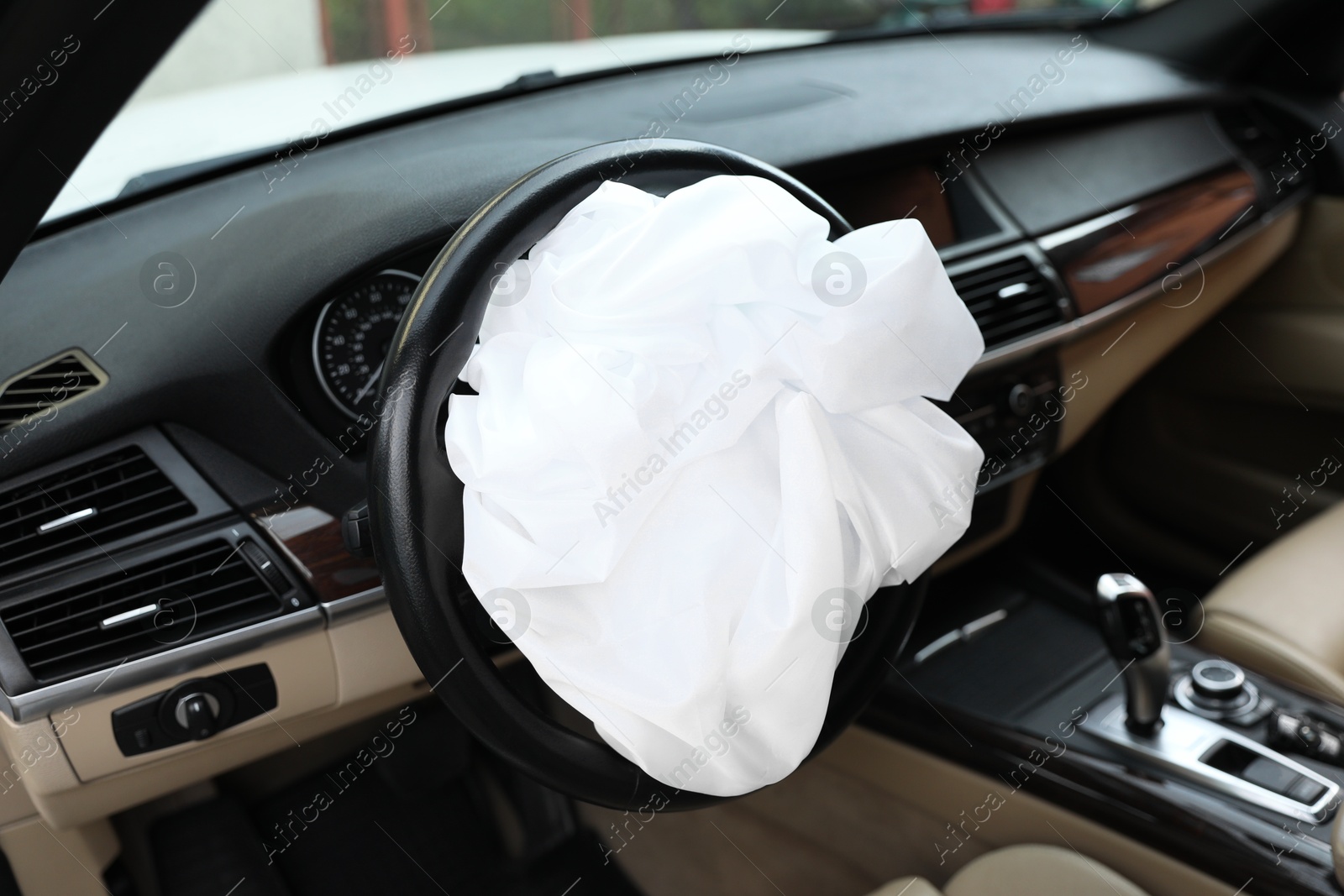 Photo of Opened airbag in automobile, closeup. Car safety equipment