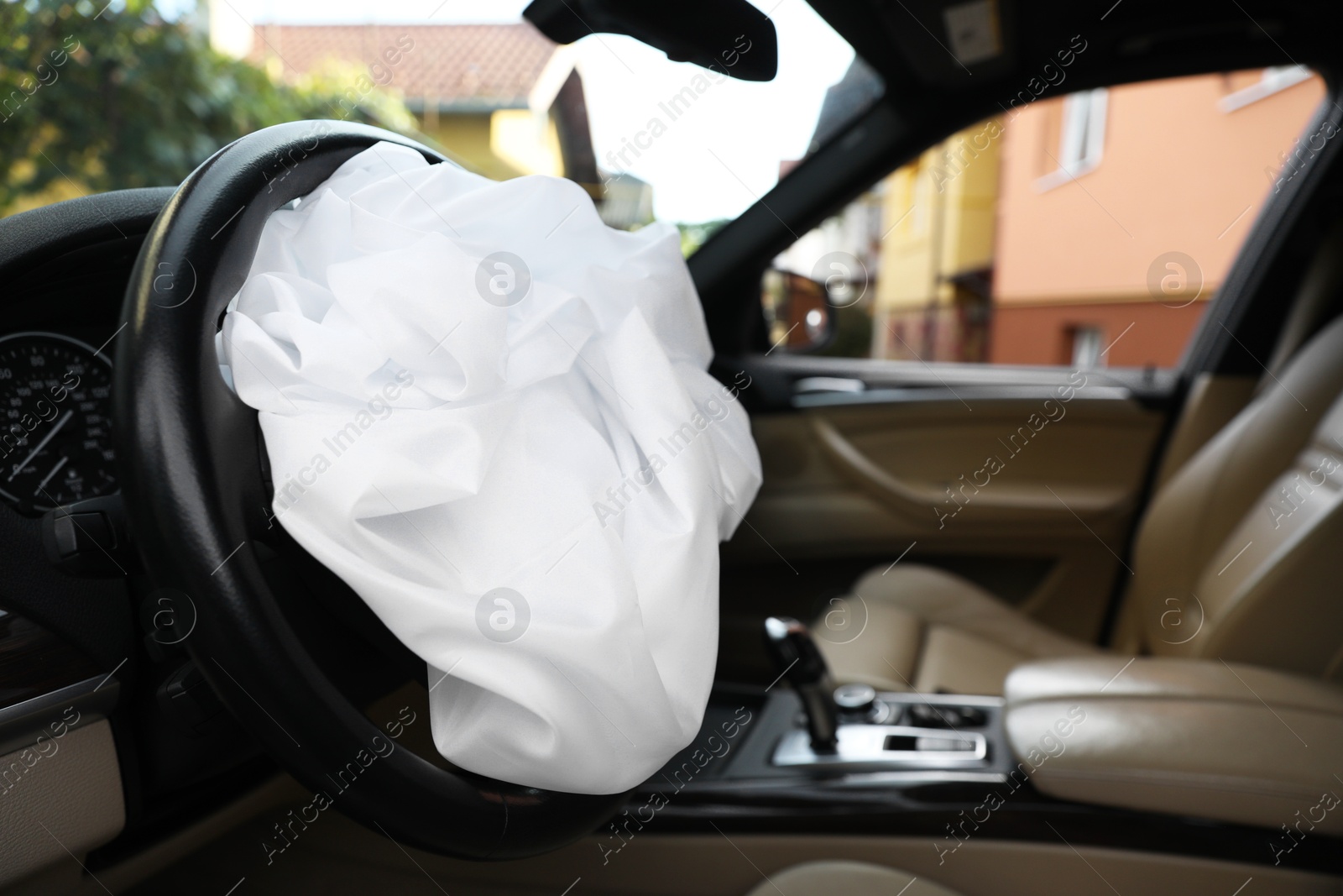 Photo of Opened airbag in automobile, closeup. Car safety equipment