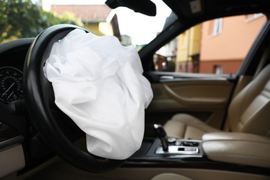 Opened airbag in automobile, closeup. Car safety equipment