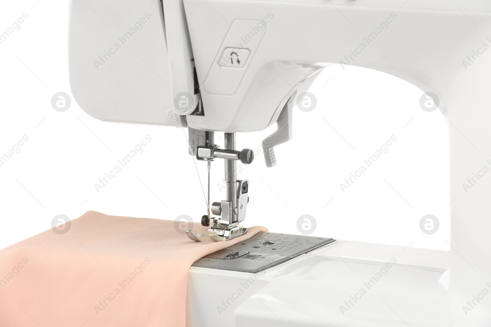 Photo of Sewing machine with cloth isolated on white