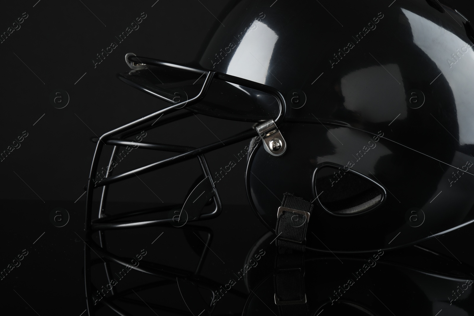 Photo of One baseball helmet on black background, closeup