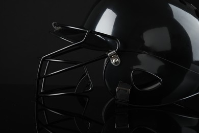 Photo of One baseball helmet on black background, closeup