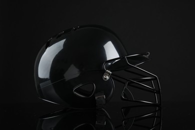 Photo of One modern baseball helmet on black background