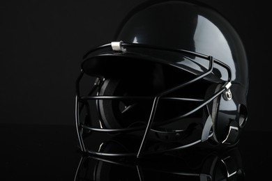 Photo of One baseball helmet on black background, closeup