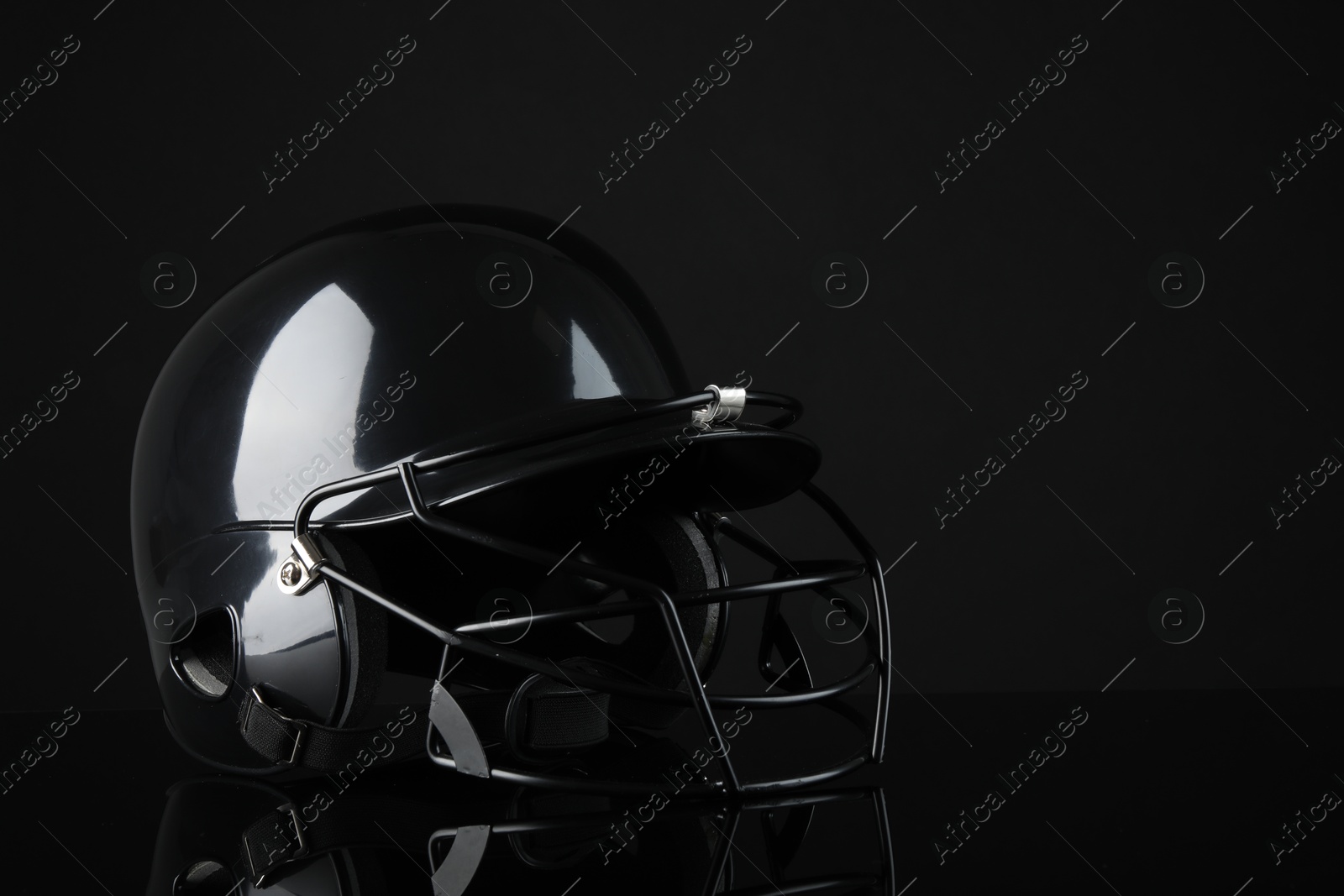 Photo of One baseball helmet on black background, space for text