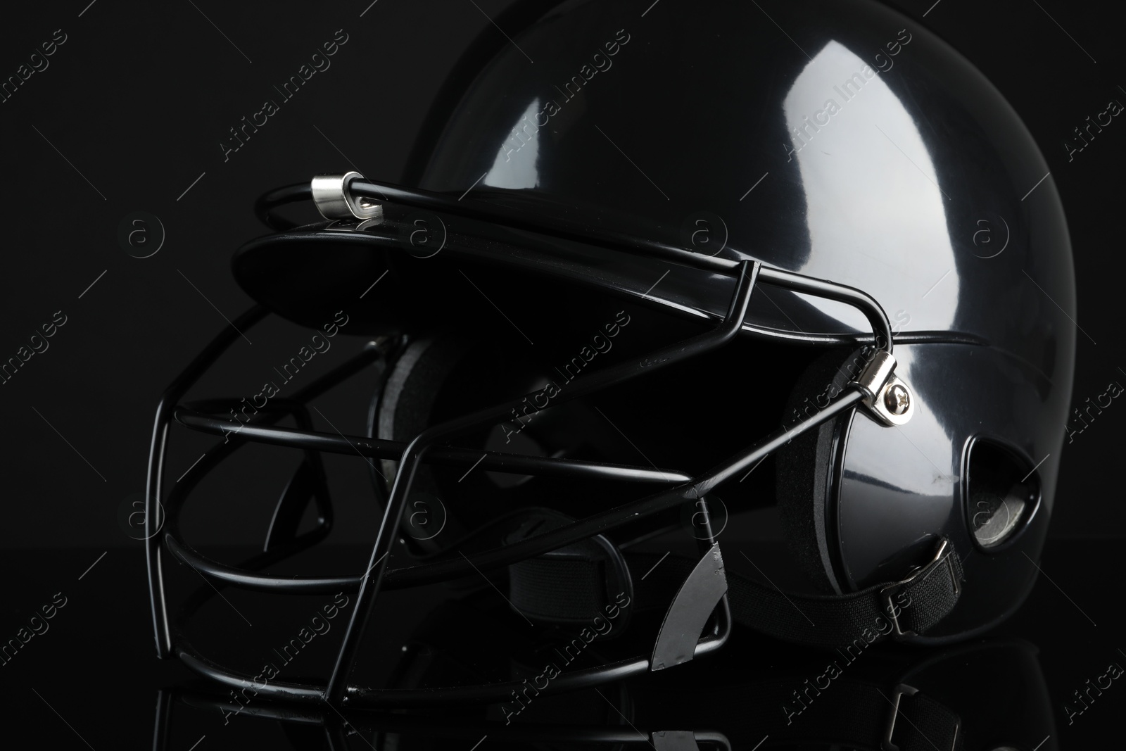 Photo of One baseball helmet on black background, closeup