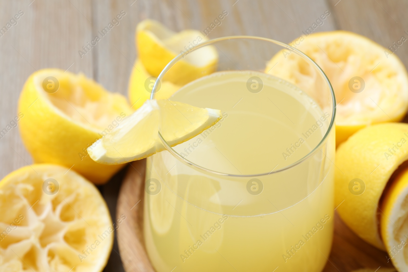 Photo of Glass of fresh juice and fruits on wooden table, closeup