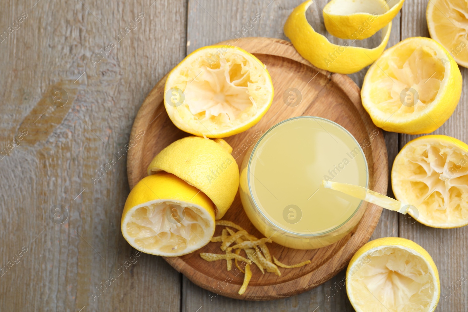 Photo of Glass of fresh juice and fruits on wooden table, flat lay