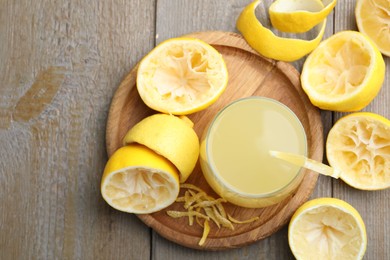 Glass of fresh juice and fruits on wooden table, flat lay