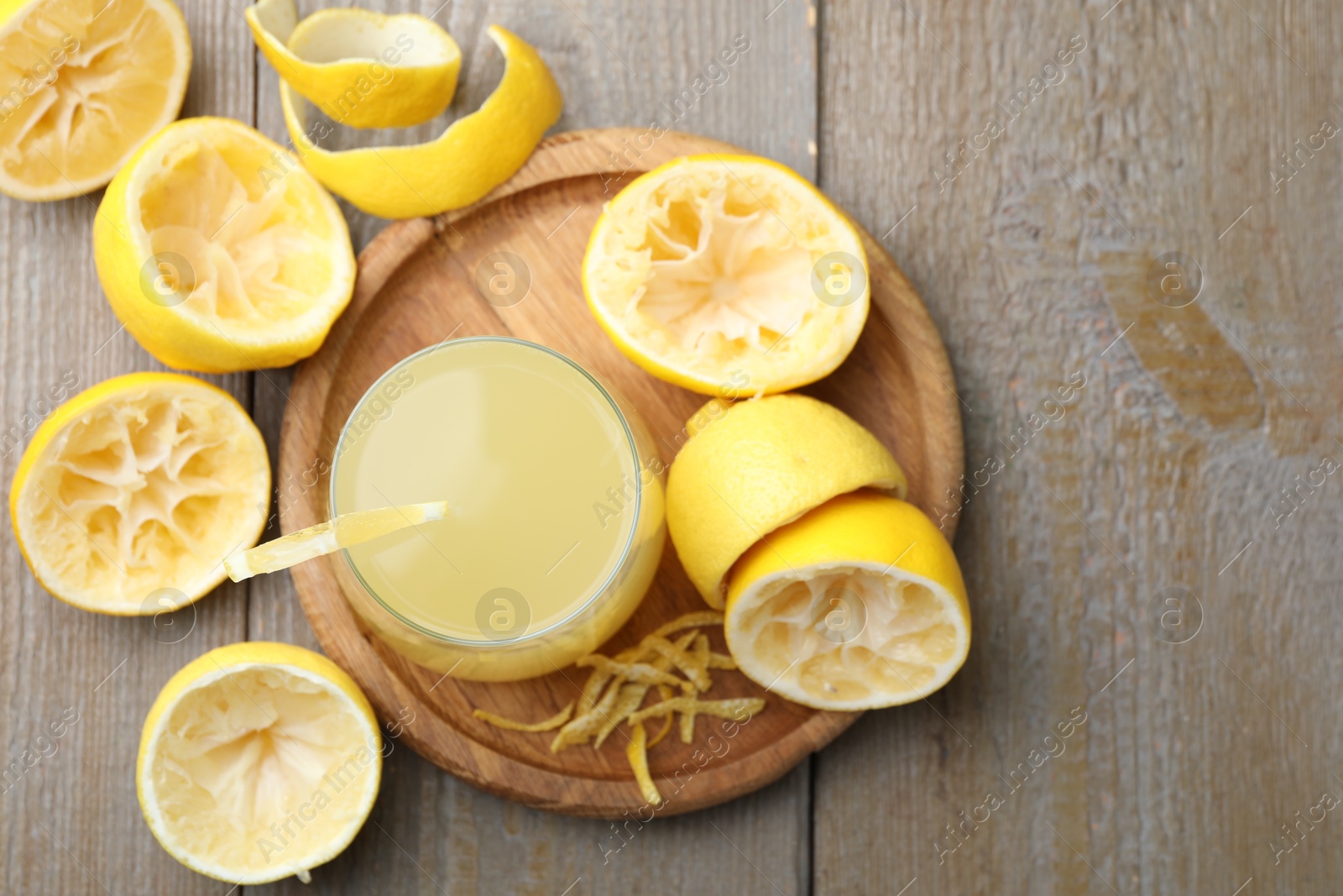 Photo of Glass of fresh juice and fruits on wooden table, flat lay