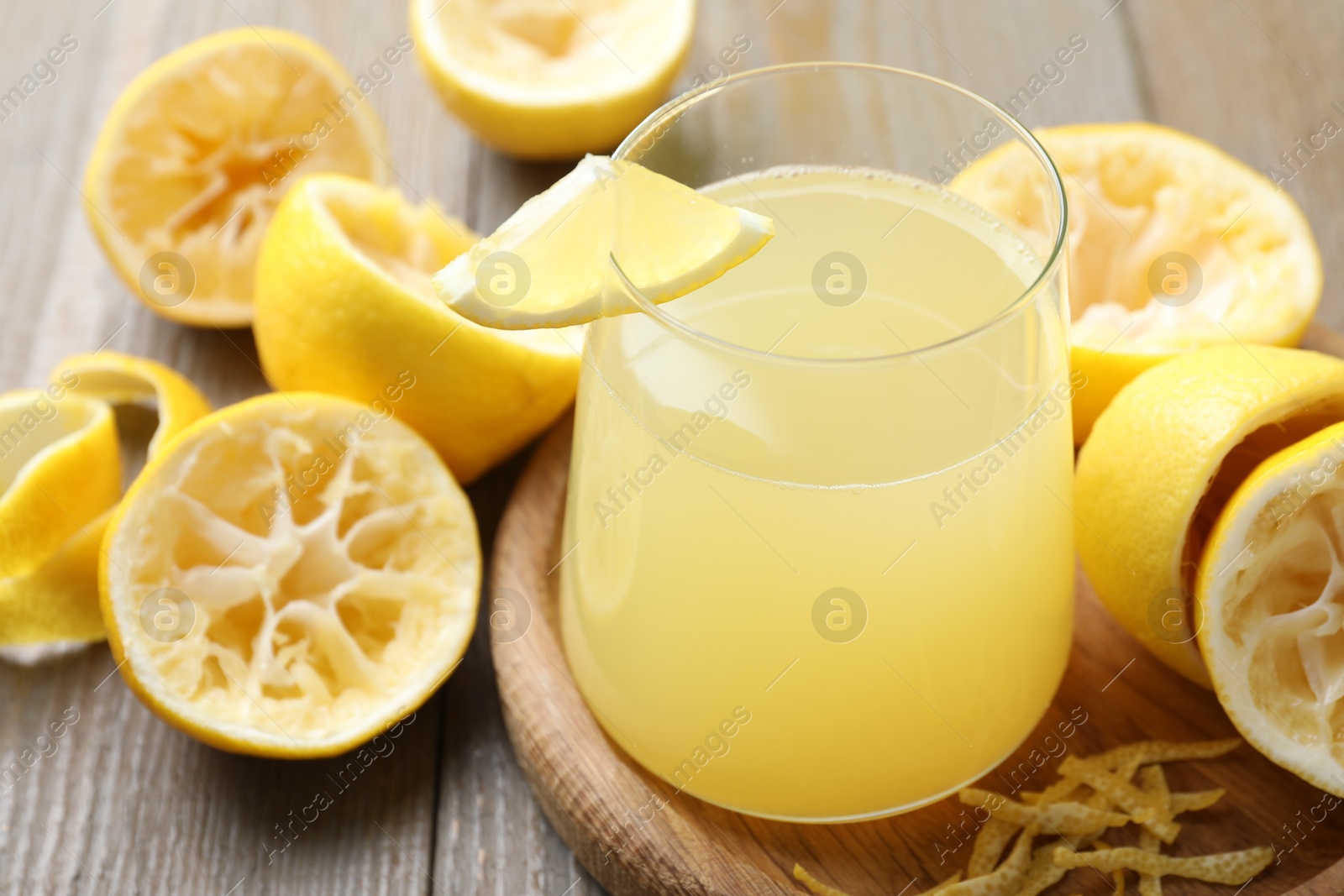 Photo of Glass of fresh juice and fruits on wooden table, closeup