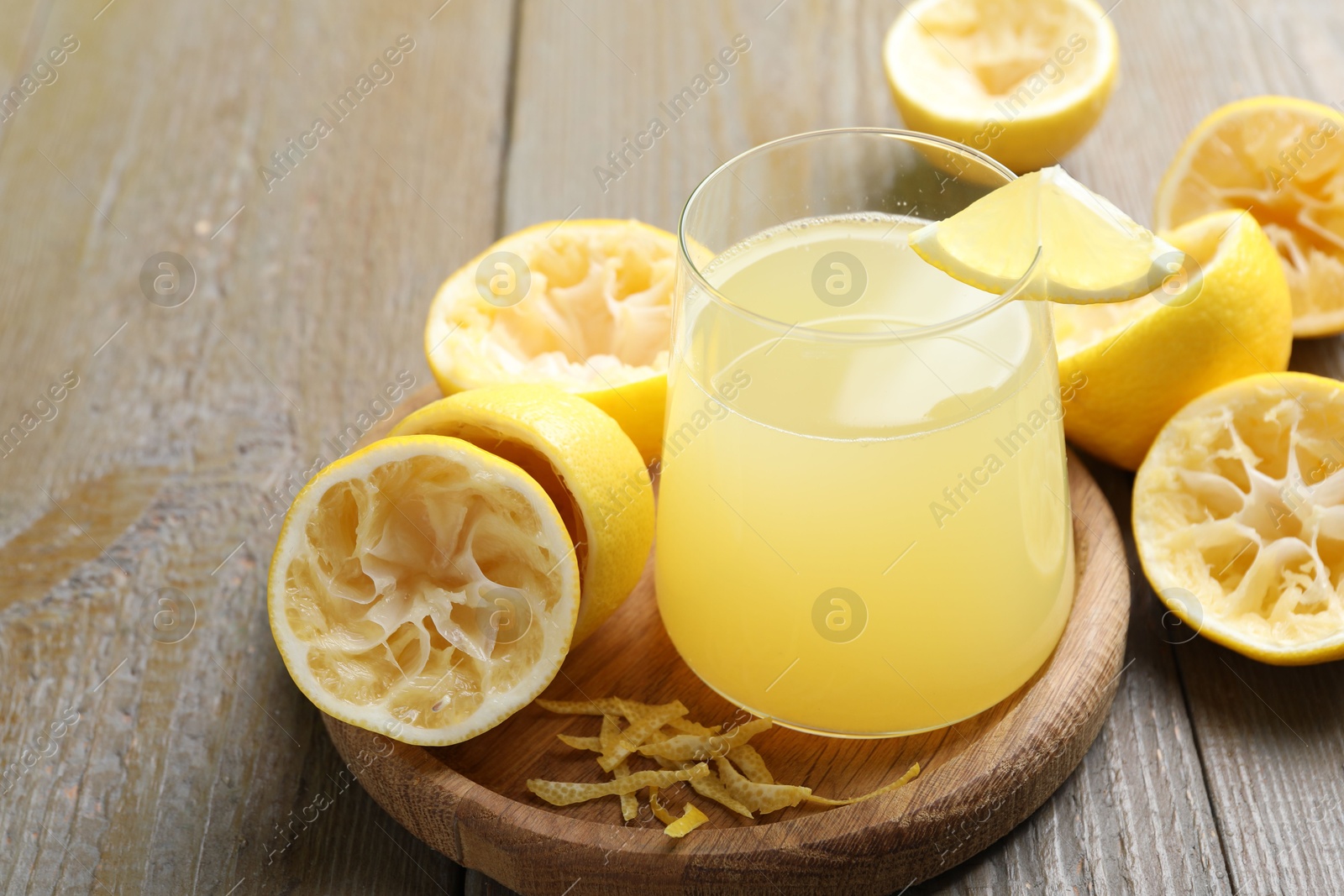 Photo of Glass of fresh juice and fruits on wooden table, closeup