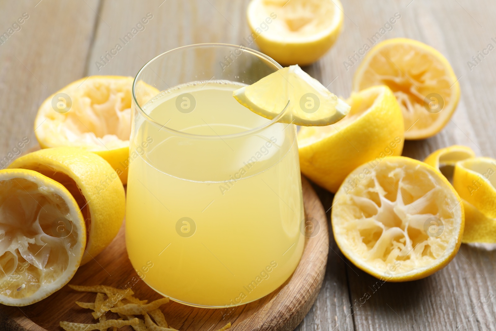 Photo of Glass of fresh juice and fruits on wooden table, closeup