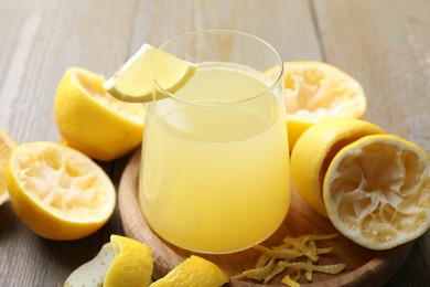 Photo of Glass of fresh juice and fruits on wooden table, closeup