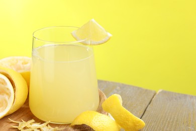 Photo of Glass of fresh juice and fruits on wooden table, closeup