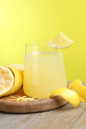 Photo of Glass of fresh juice and fruits on wooden table