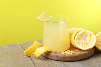 Photo of Glass of fresh juice and fruits on wooden table