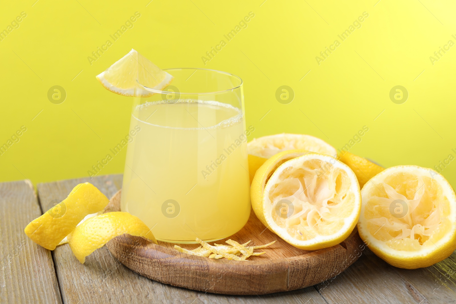 Photo of Glass of fresh juice and fruits on wooden table