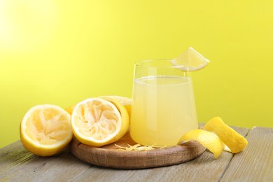 Photo of Glass of fresh juice and fruits on wooden table