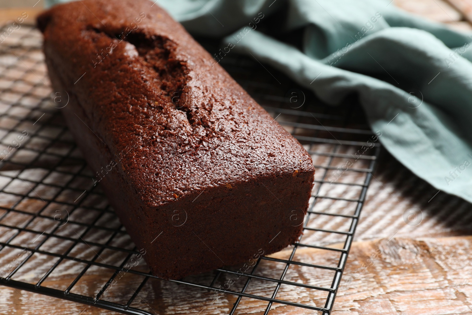 Photo of Tasty chocolate sponge cake on wooden table, closeup