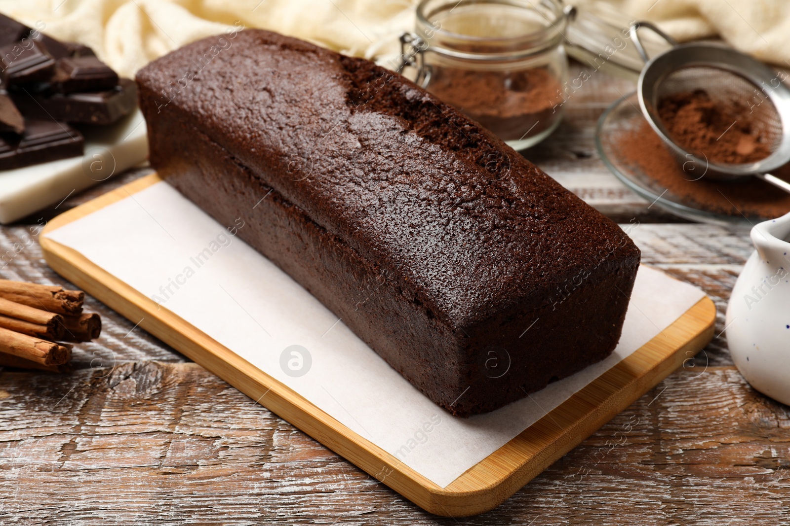 Tasty chocolate sponge cake on wooden table, closeup Photo of Tasty chocolate sponge cake on wooden table, closeup