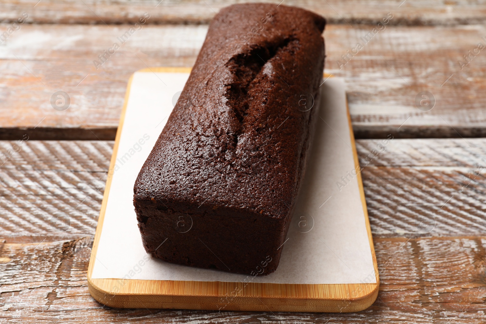 Tasty chocolate sponge cake on wooden table, closeup Photo of Tasty chocolate sponge cake on wooden table, closeup