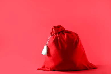 Photo of One Santa Claus bag on red background, space for text