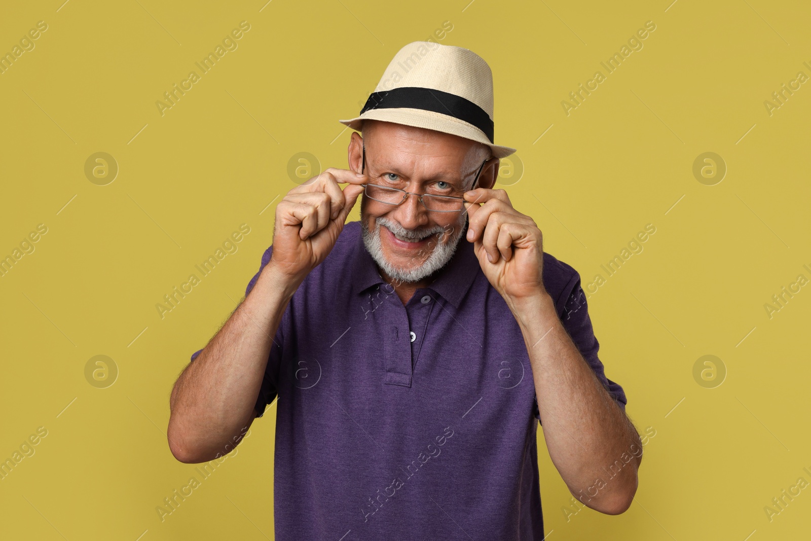 Photo of Portrait of handsome senior man on yellow background