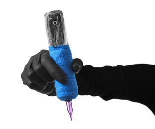 Photo of Professional artist in gloves holding tattoo machine on white background, closeup