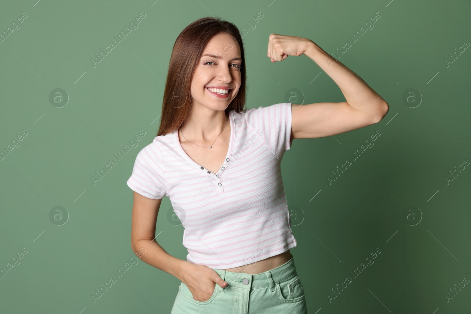 Photo of Portrait of happy winner on green background