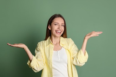 Portrait of happy winner on green background